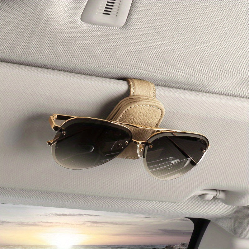 Stylish magnetic PU leather glasses holder for car visor with black textured grip. Compact design for easy access and secure storage.