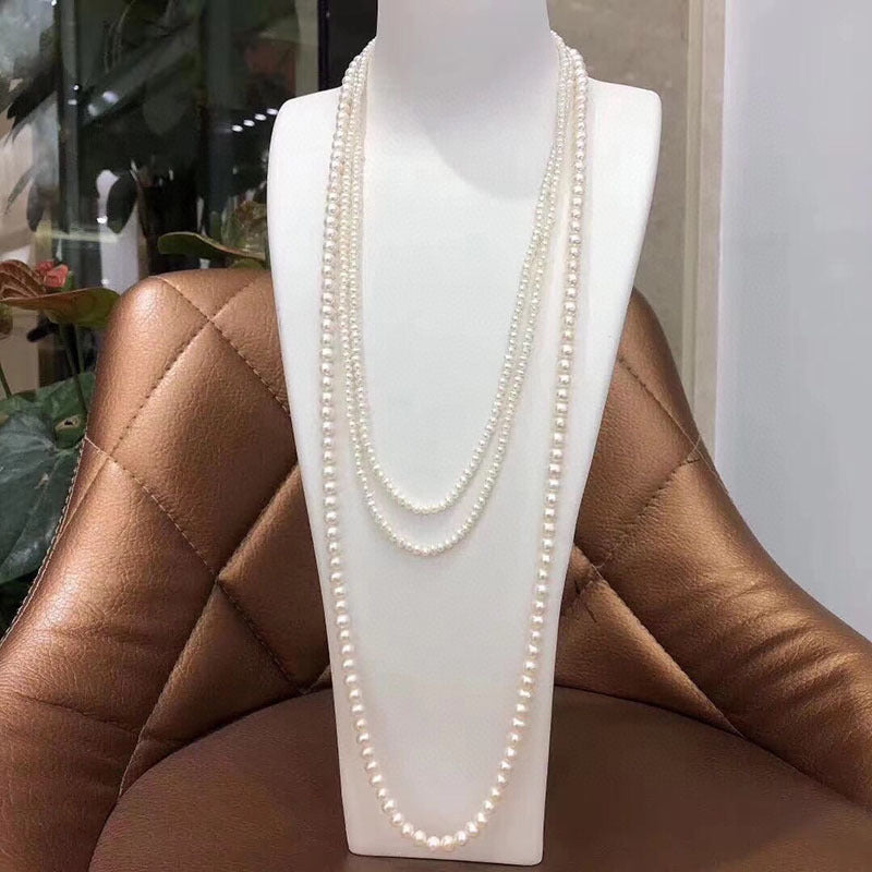 This multi-layered freshwater pearl sweater necklace exudes elegance with its combination of 3-4mm and 7-8mm beads. Perfect for special occasions such as dates, weddings, proposals, Mother's Day, Valentine's, and anniversaries. Comes in a gift box for a