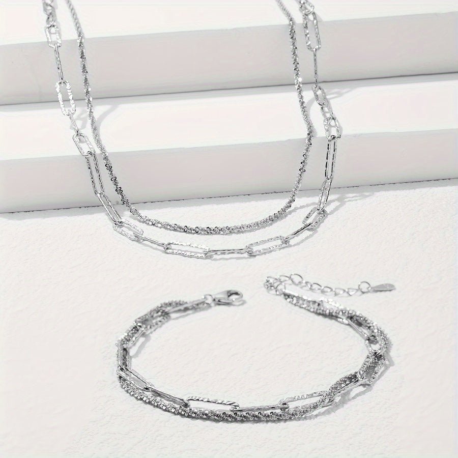 2-piece set includes a boho chic 925 silvery plated necklace and bracelet featuring a multi-layer paperclip chain design. This set is perfect for daily wear or as a stylish party accessory.