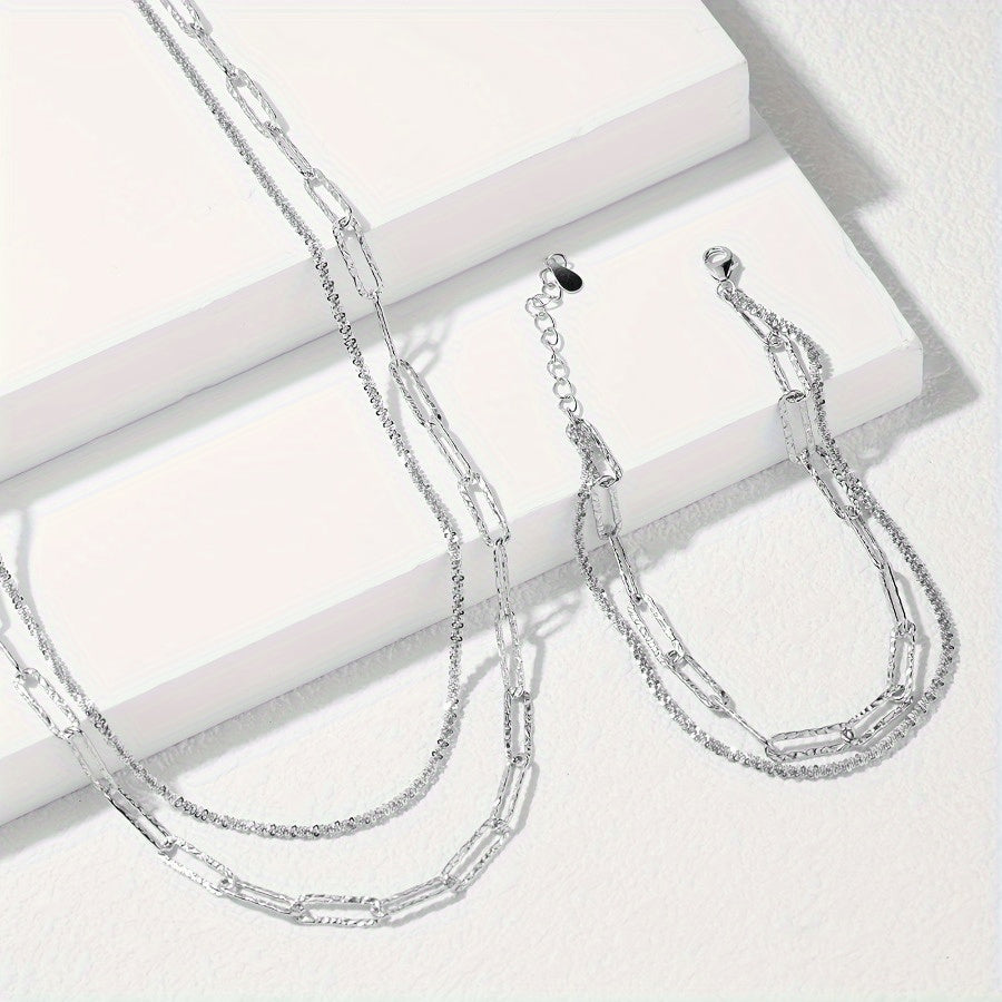 2-piece set includes a boho chic 925 silvery plated necklace and bracelet featuring a multi-layer paperclip chain design. This set is perfect for daily wear or as a stylish party accessory.