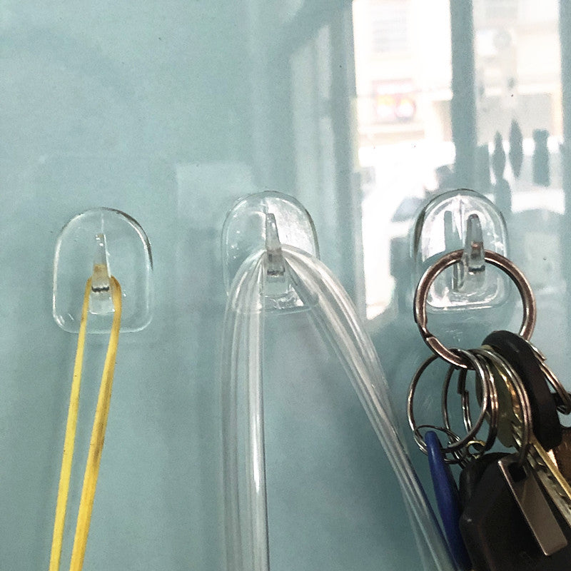 10 clear acrylic sticky hooks with cow horn design for strong, drill-free wall attachment in bathroom and kitchen. Rust-resistant and durable.