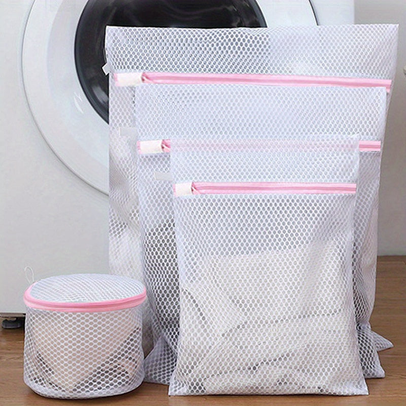 Mesh laundry bags with zippers in a 4-pack, designed for durability and convenient washing of clothes, underwear, and even cooked food. These multi-purpose rectangular fabric bags are ideal for use in the washing machine.