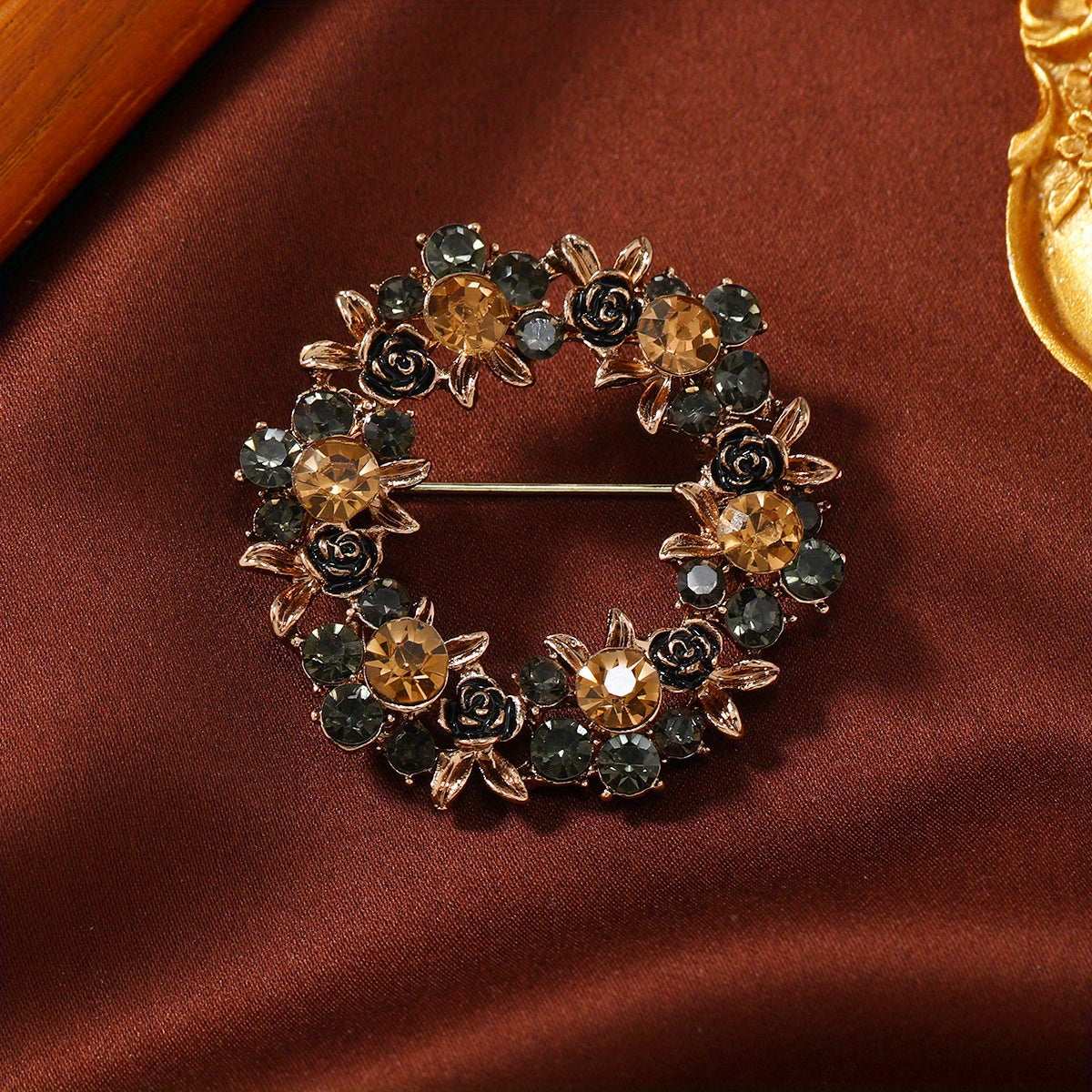 Vintage-inspired crystal garland brooch pin with elegant design and rhinestone accents, ideal for adding a touch of sophistication to dresses and sweaters.