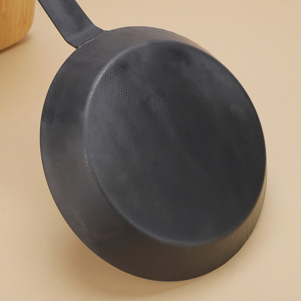 One piece of carbon steel steak pot with a Japanese-style design, perfect for household use. This specialty dry pot is portable and has an uncoated, non-stick pan with a flat bottom and long handle. It is ideal for frying steaks and a must-have kitchen