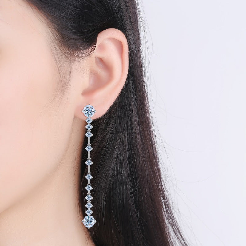 These vintage-inspired tassel earrings feature a pair of 6CT Moissanite stones set in 18K golden plated 925 sterling silver. Delicate and cute, these earrings are perfect for women to wear daily, while on vacation, on Mardi Gras Day, or in any season.