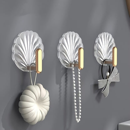 4 elegant waterproof adhesive hooks with golden accents for hanging items in kitchen, bathroom, or bedroom.