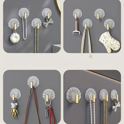 4 elegant waterproof adhesive hooks with golden accents for hanging items in kitchen, bathroom, or bedroom.