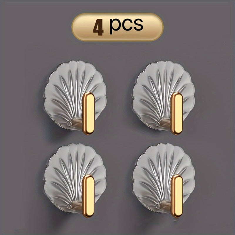 4 elegant waterproof adhesive hooks with golden accents for hanging items in kitchen, bathroom, or bedroom.