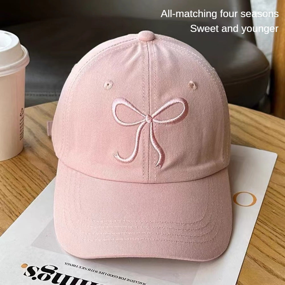 Adjustable bowknot baseball cap in sweet pink design, made of lightweight polyester. Comes in black, grey, apricot, and pink for casual wear.