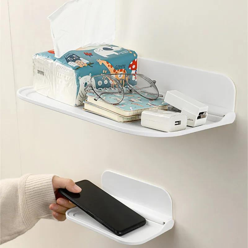 The Wall-Mounted Plastic Storage Shelf with Towel Rack is a versatile organizer for your bathroom. It features a foldable design that requires no drilling for installation. This shelf includes a mobile phone holder, soap dispenser, and paper towel