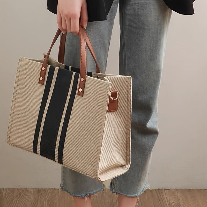 Durable and stylish striped canvas tote bag for women, perfect for work, school, and travel. Features soft handles and spacious interior with beige & black striped design. Built to last.