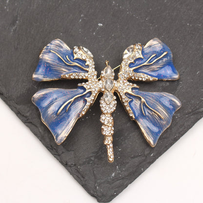 Chic Enamel Dragonfly Brooch adorned with Rhinestones, Unique Shape Fashion Pin for Clothing and Festive Gifts, exuding Luxury and Elegance.