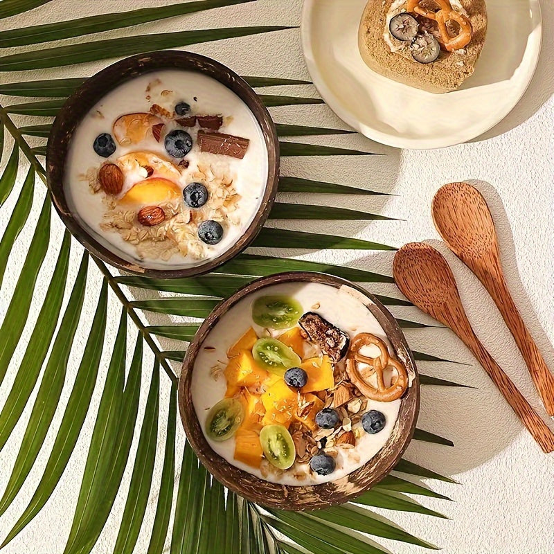 Set of two handcrafted coconut shell salad bowls with matching wooden spoons - Eco-friendly and ideal for serving salads, fruits, and cereals