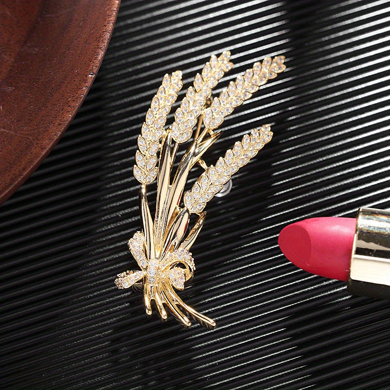 Stylish antique wheat sheaf brooch adorned with a delicate bow and shimmering rhinestones, a nature-inspired fashion accessory for both men and women.