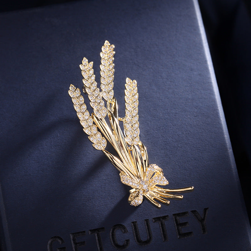 Stylish antique wheat sheaf brooch adorned with a delicate bow and shimmering rhinestones, a nature-inspired fashion accessory for both men and women.