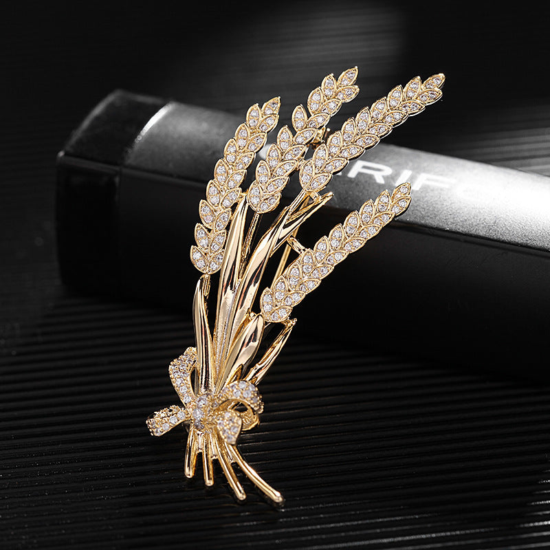 Stylish antique wheat sheaf brooch adorned with a delicate bow and shimmering rhinestones, a nature-inspired fashion accessory for both men and women.