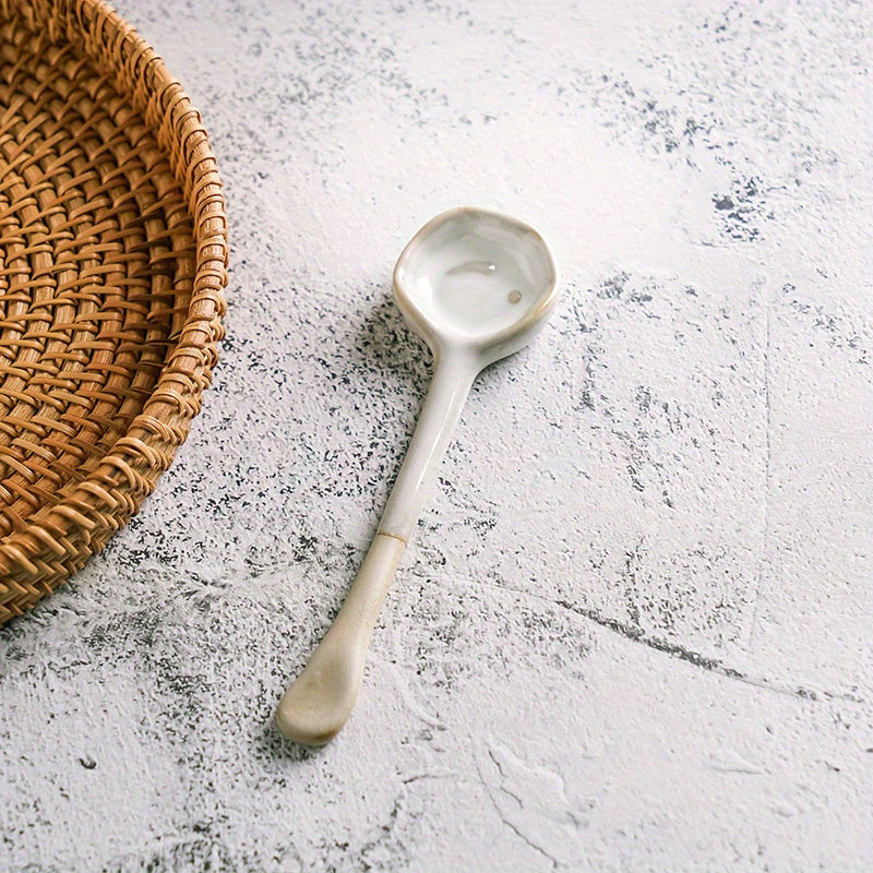 This long-handled Japanese ceramic coffee spoon has a rustic charm and is ideal for stirring tea or coffee. Made of heat-resistant ceramic material, it serves as a stylish accessory for your kitchen and dining experience.