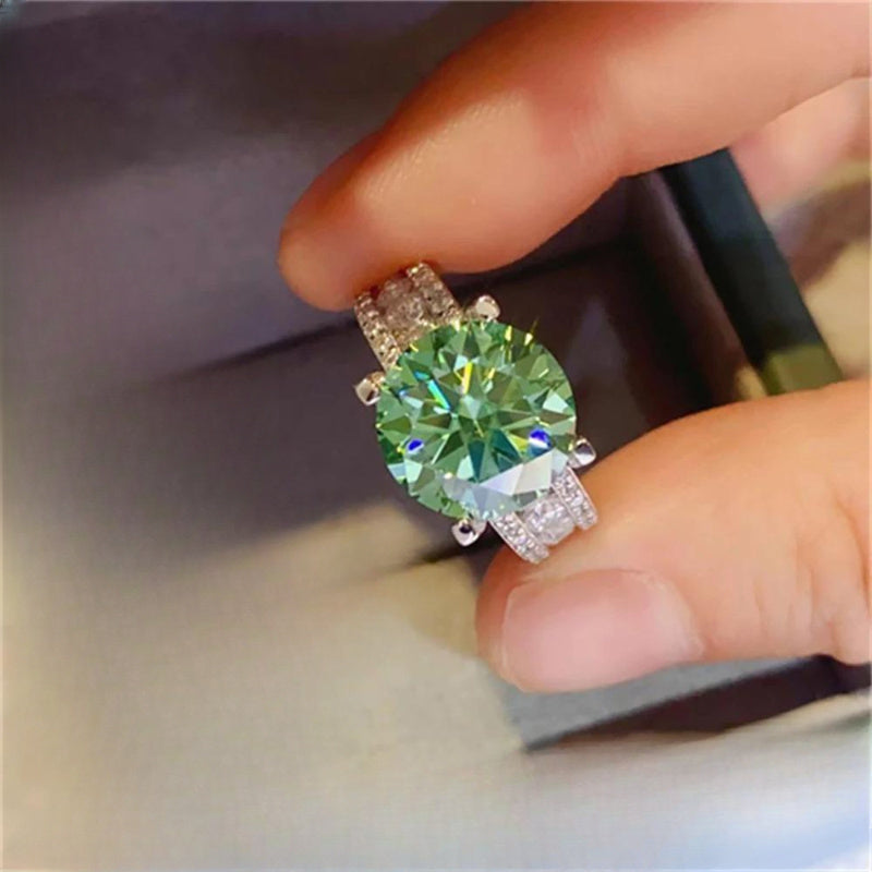 Gorgeous Blue-Green Moissanite Engagement Ring - Available in 3, 5, or 10 Carats, Set in Luxurious 925 Sterling Silver with 4 Prongs. The Perfect Gift for Her on Valentine's Day and Beyond. Let Your Love Spark and Grow with This Stunning Ring.