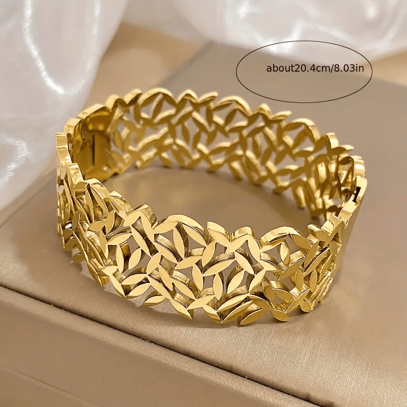 A stylish stainless steel bangle for women, featuring a delicate two-tone design with an irregular hollowed-out leaf bird's nest pattern. This fashionable botanical accessory is perfect for adding a touch of elegance to any outfit and makes a great gift