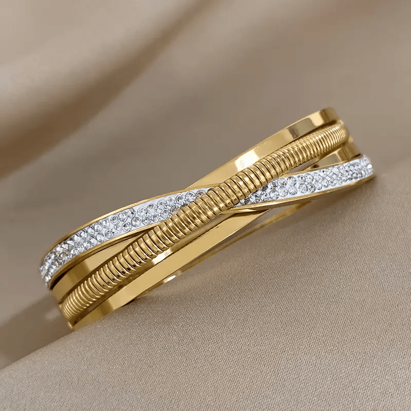 Simple and elegant, this beautiful triple-strand bracelet is plated with 18K golden stainless steel and adorned with synthetic cubic zirconia stones. Perfect for everyday wear or vacations, its classic style is versatile and timeless.