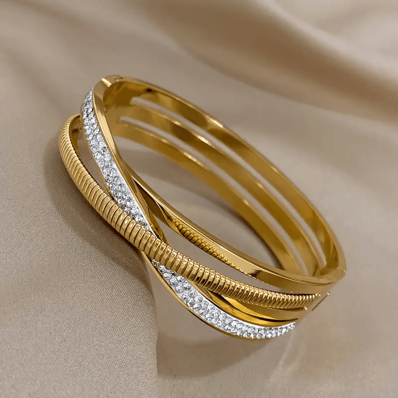 Simple and elegant, this beautiful triple-strand bracelet is plated with 18K golden stainless steel and adorned with synthetic cubic zirconia stones. Perfect for everyday wear or vacations, its classic style is versatile and timeless.