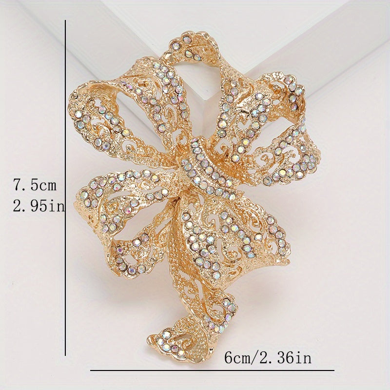 Chic and sophisticated, this exquisite Rhinestone Ribbon Bow Brooch adds a touch of luxury to any outfit. This high-end fashion accessory is a must-have for those looking to stand out with personalized style. Featuring an irregular shape design, this