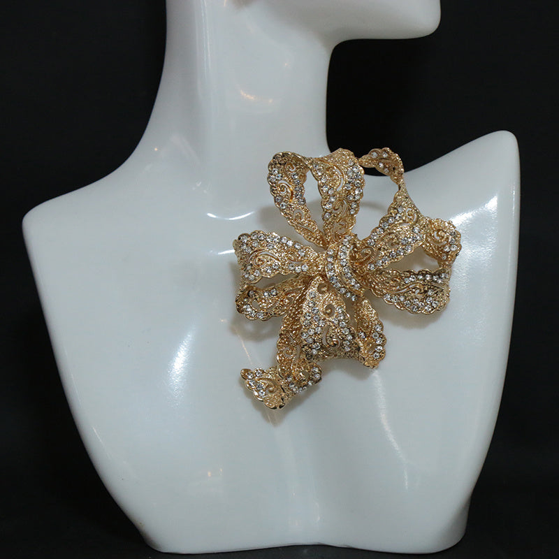 Chic and sophisticated, this exquisite Rhinestone Ribbon Bow Brooch adds a touch of luxury to any outfit. This high-end fashion accessory is a must-have for those looking to stand out with personalized style. Featuring an irregular shape design, this