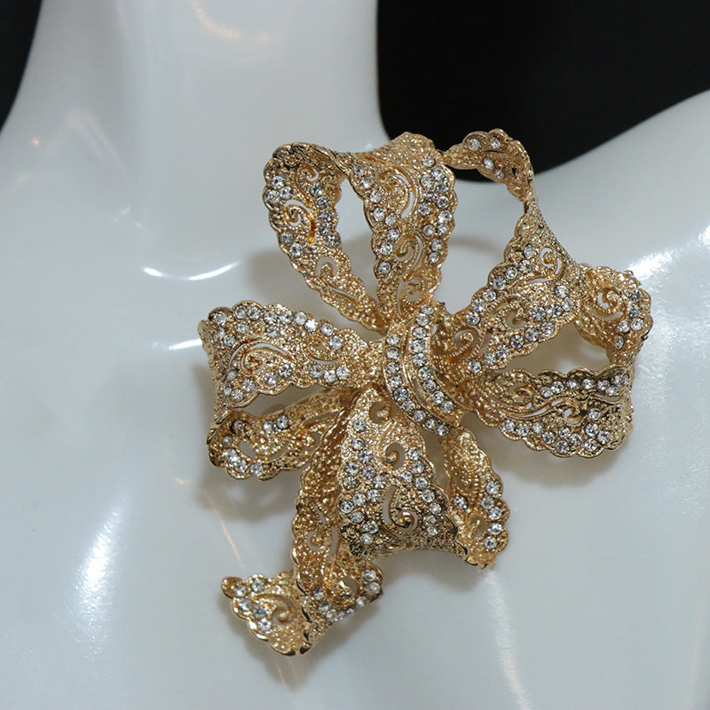 Chic and sophisticated, this exquisite Rhinestone Ribbon Bow Brooch adds a touch of luxury to any outfit. This high-end fashion accessory is a must-have for those looking to stand out with personalized style. Featuring an irregular shape design, this