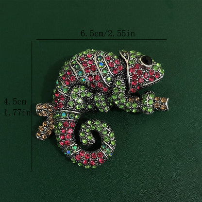 This stylish brooch pin features luxurious rhinestones and is designed in an elegant chameleon shape. The fashionable green and pink crystals adorn the piece, creating a unique and irregular shape. This versatile accessory can be worn as chest jewelry or