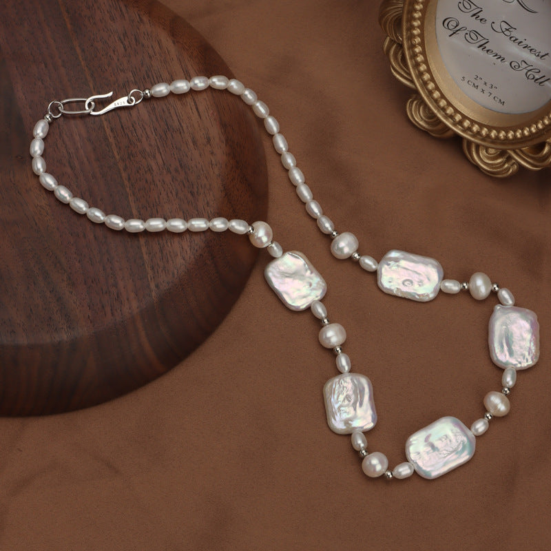 Elegant and fashionable, the ZAYCAN Baroque Art Pearl Necklace features a vintage petal design with natural freshwater pearls on a silvery body. This accessory adds a touch of vintage style to any outfit and is perfect for banquets, weddings, or as a