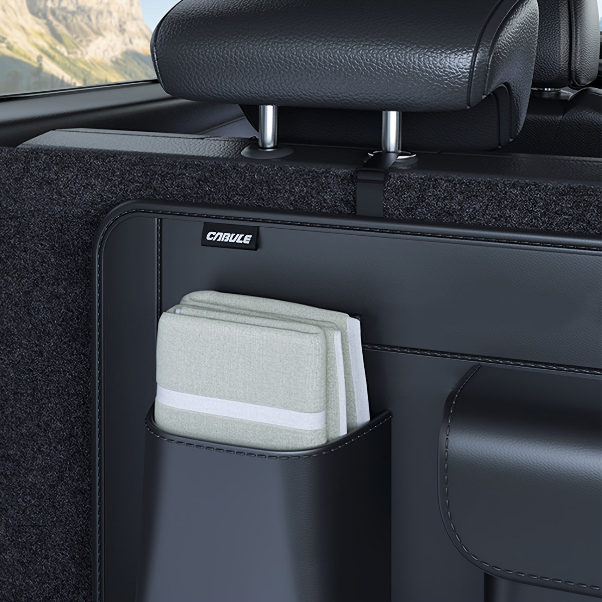 Car trunk storage bag for organizing miscellaneous items.