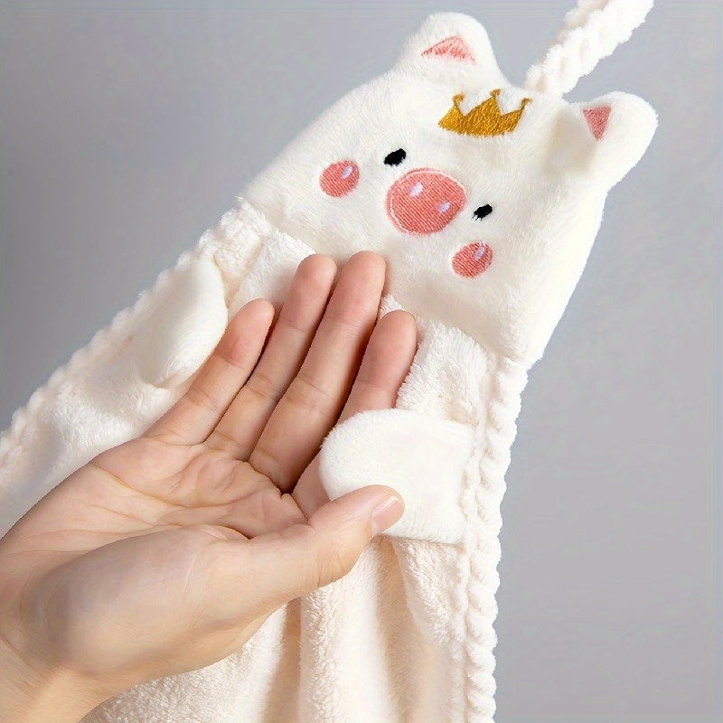 Cute pig-shaped hand towel made of soft coral velvet, quick-drying and absorbent for kitchen and bathroom use. Features hanging loop, gentle on hands, and plush texture. Perfect functional decor item for your bathroom.