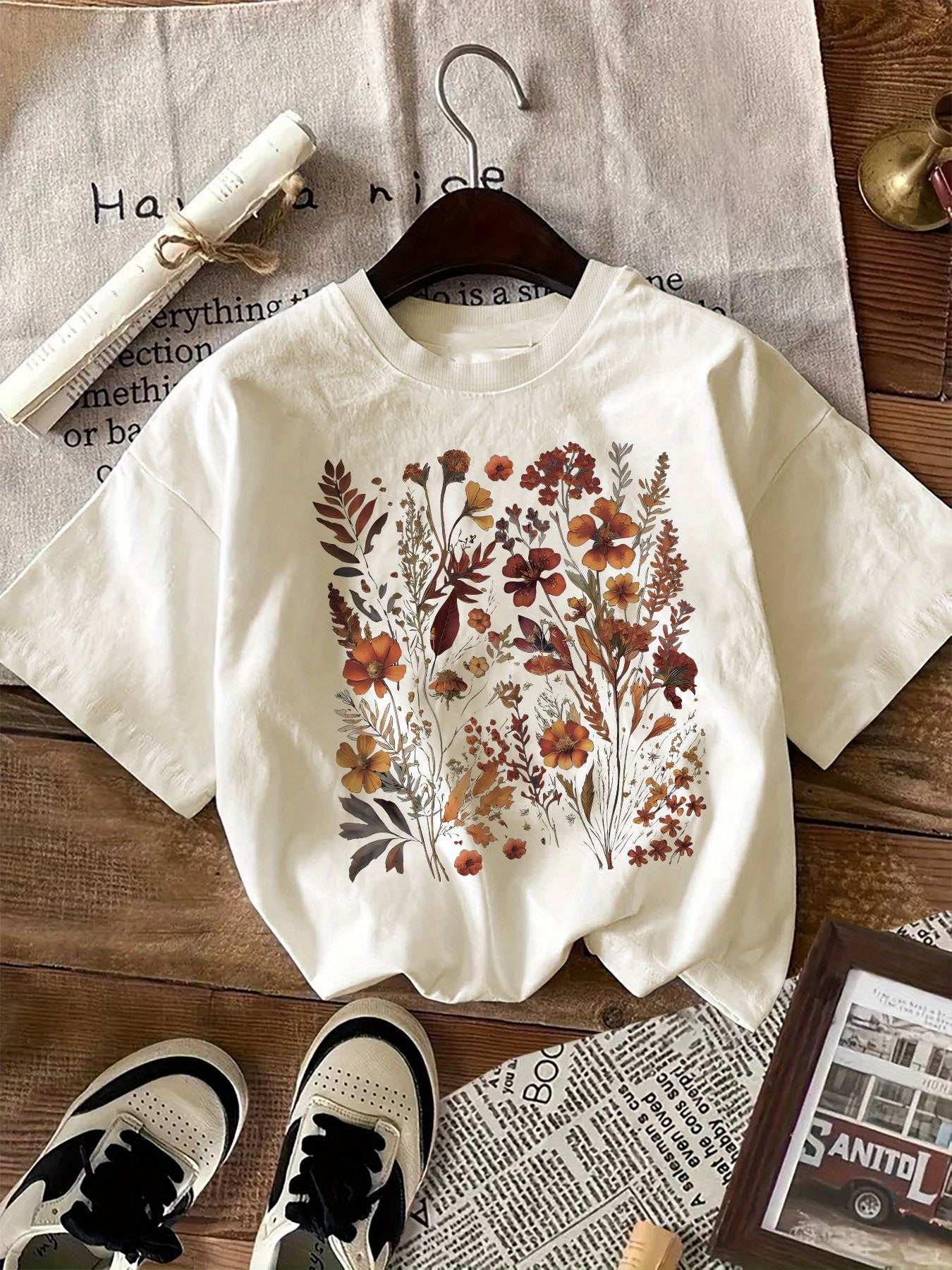 Women's floral graphic print t-shirt with crew neck, short sleeves, and regular length, suitable for all seasons. Made of 100% knit fabric weighing 180gsm.