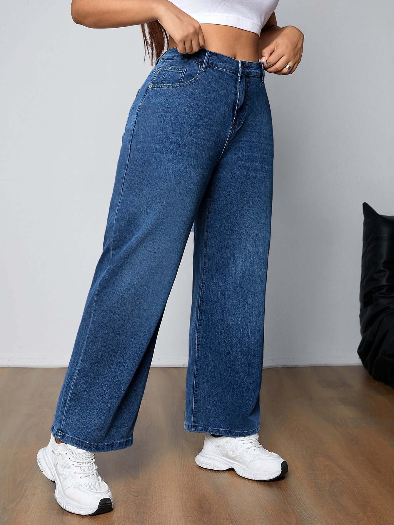 Plus size women's high-rise washed blue jeans with button fly, stretchy straight leg fit, and plain design.