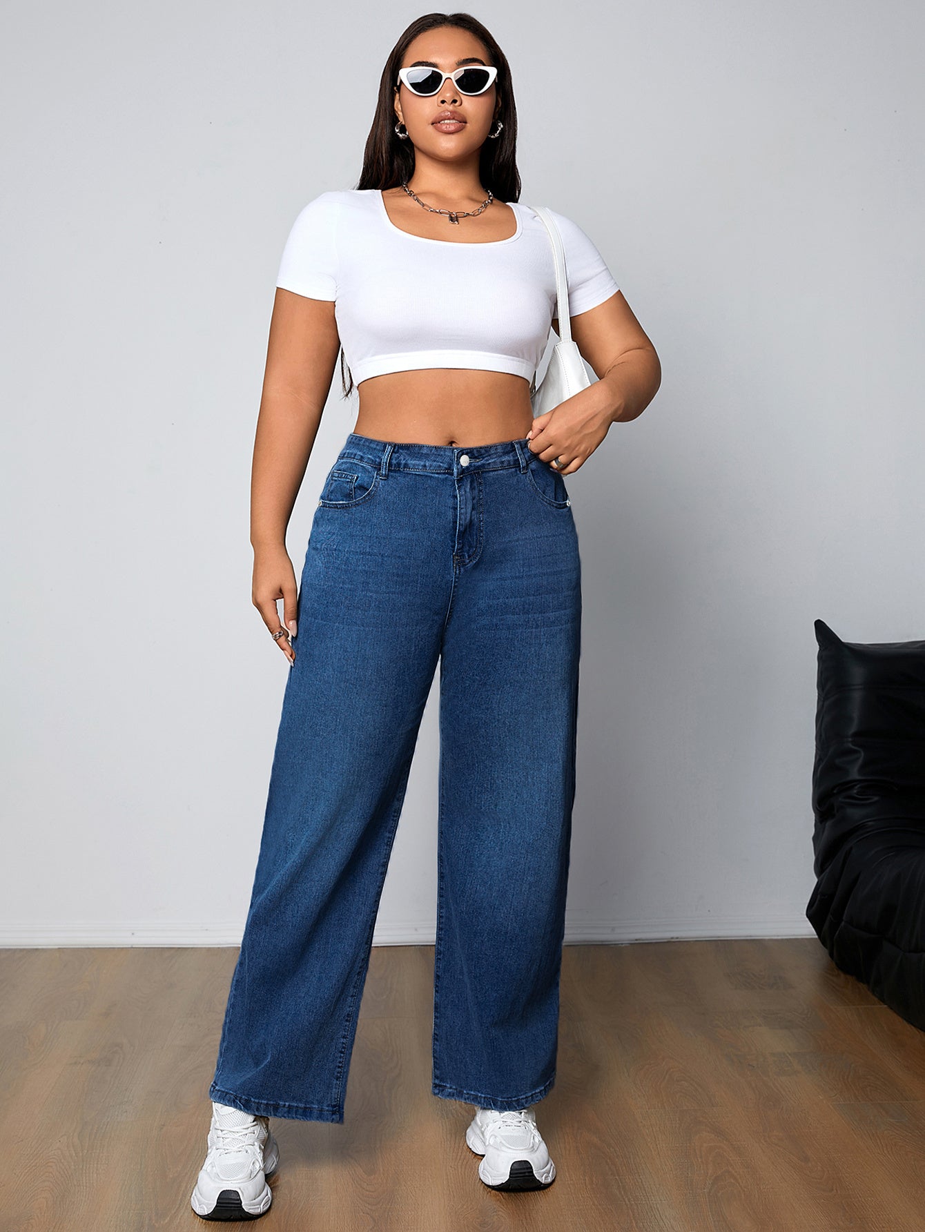 Plus size women's high-rise washed blue jeans with button fly, stretchy straight leg fit, and plain design.