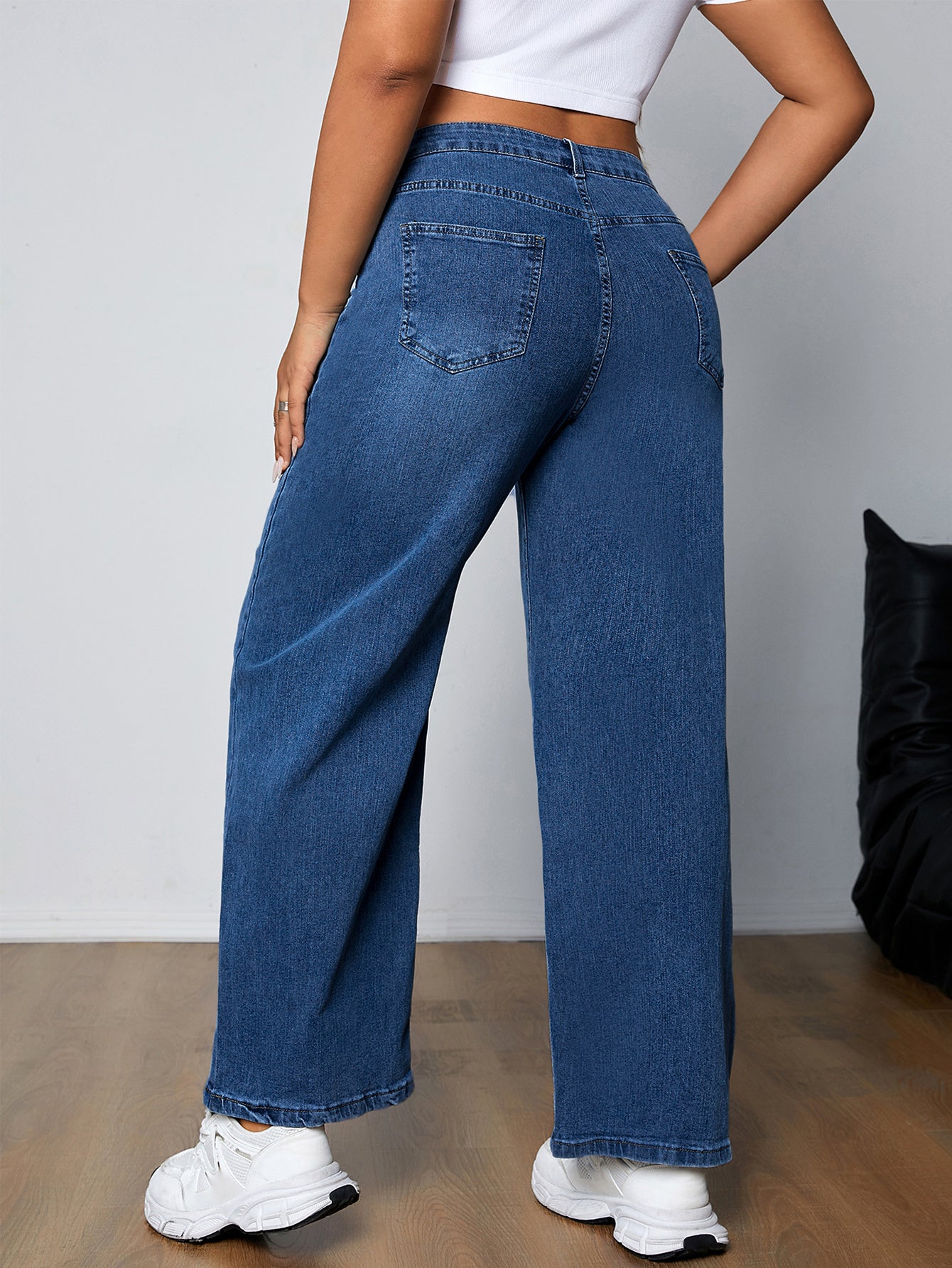 Plus size women's high-rise washed blue jeans with button fly, stretchy straight leg fit, and plain design.