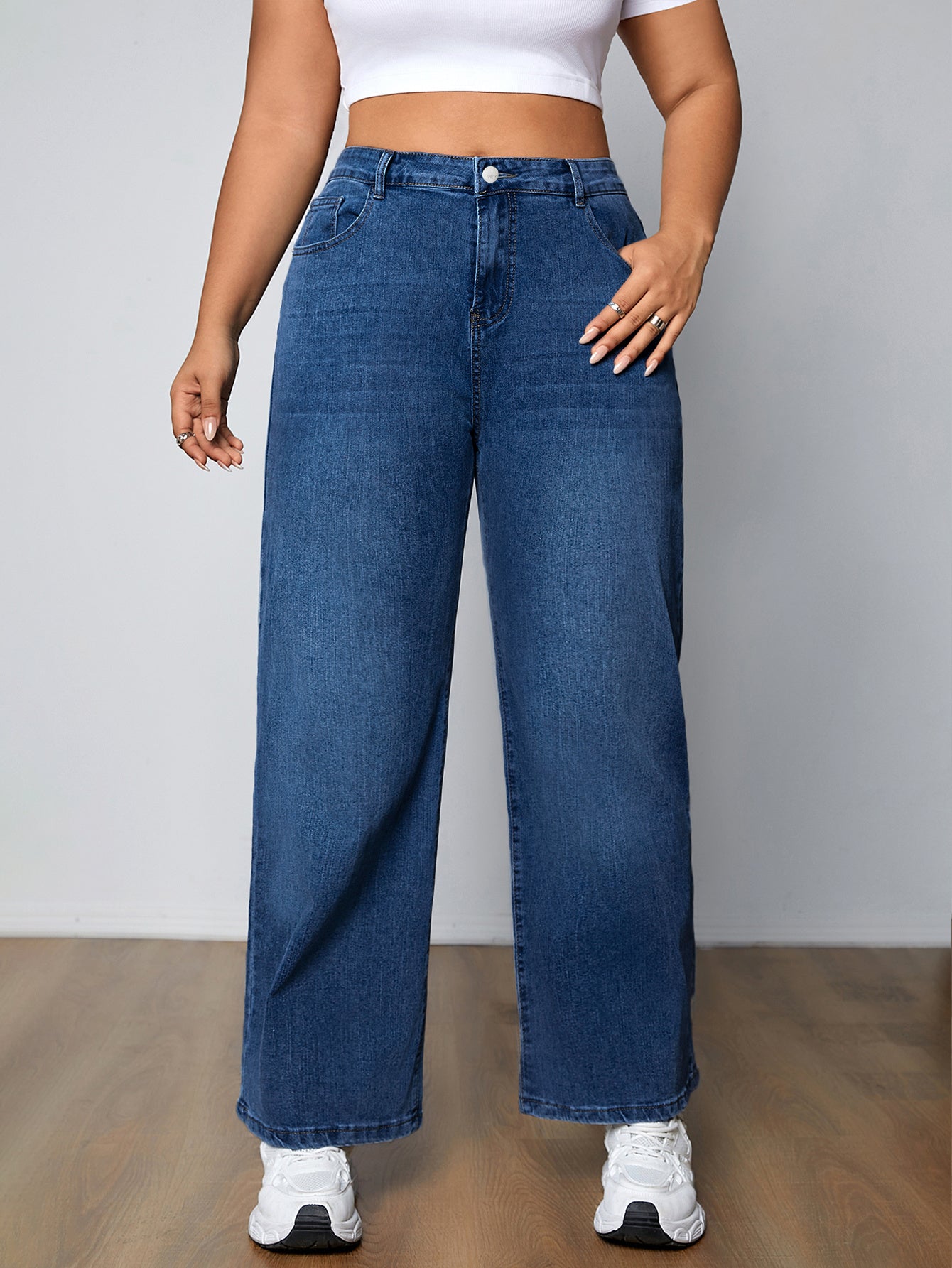 Plus size women's high-rise washed blue jeans with button fly, stretchy straight leg fit, and plain design.