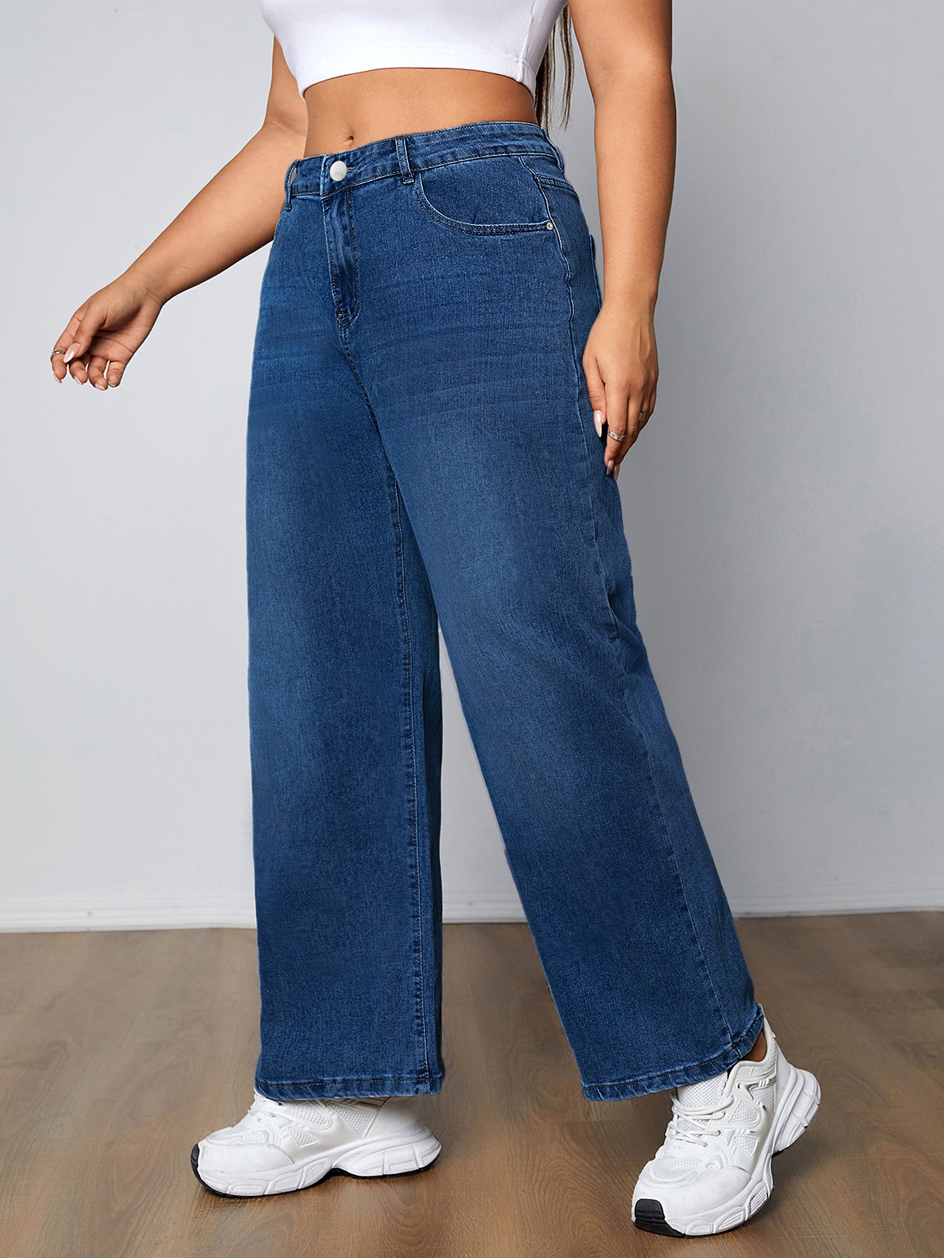 Plus size women's high-rise washed blue jeans with button fly, stretchy straight leg fit, and plain design.