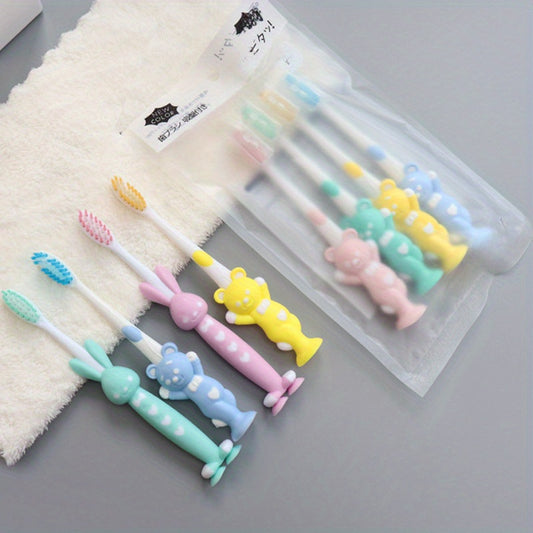 4 soft-bristled toothbrushes with charcoal and cute animal designs for teeth care.