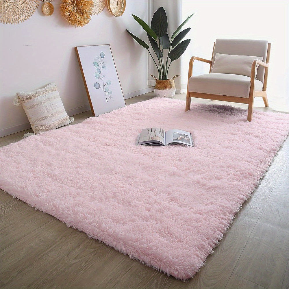 This solid pink polyester area rug is both fluffy and durable, making it perfect for any room in your home or office. The non-slip backing ensures safety, while the stain-resistant material is easy to clean with dry cleaning. This machine-made