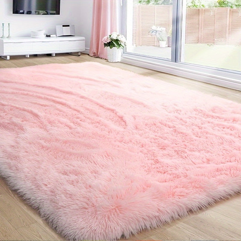 This solid pink polyester area rug is both fluffy and durable, making it perfect for any room in your home or office. The non-slip backing ensures safety, while the stain-resistant material is easy to clean with dry cleaning. This machine-made