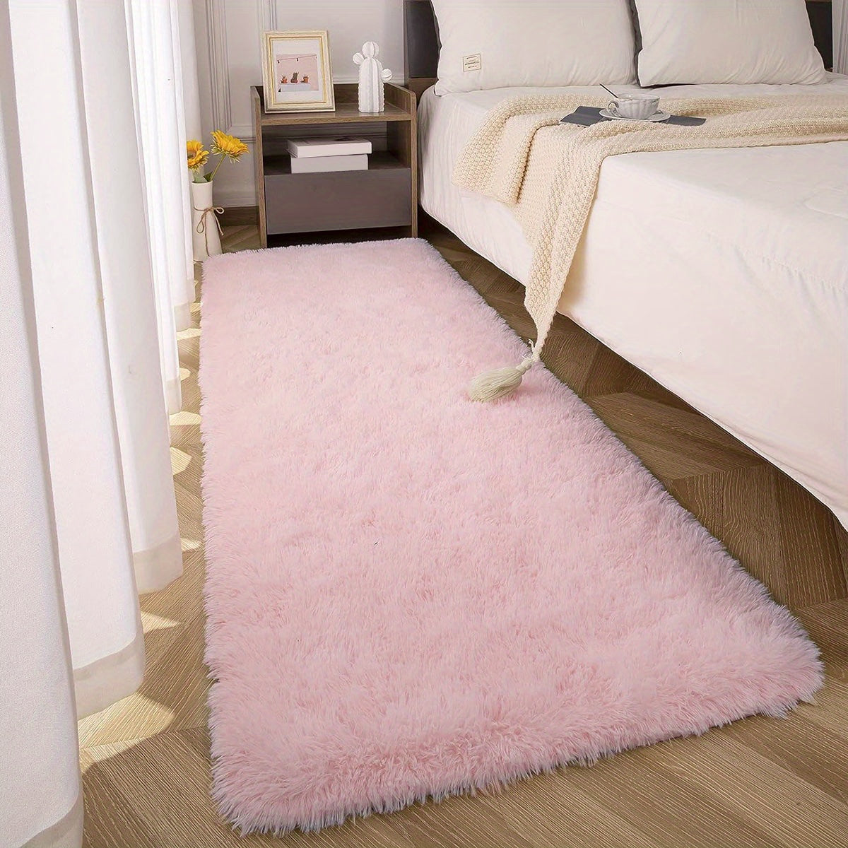 This solid pink polyester area rug is both fluffy and durable, making it perfect for any room in your home or office. The non-slip backing ensures safety, while the stain-resistant material is easy to clean with dry cleaning. This machine-made