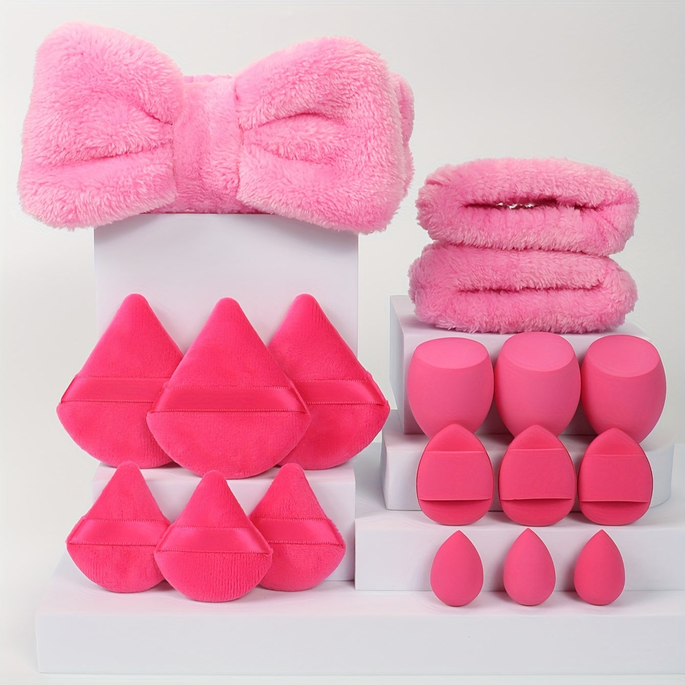 18-piece set including 1 hairband, 2 wristbands, 3 makeup sponges, 3 mini makeup sponges, 3 loose powder puffs, and 6 air cushion puffs. Features foundation mixing sponge for flawless