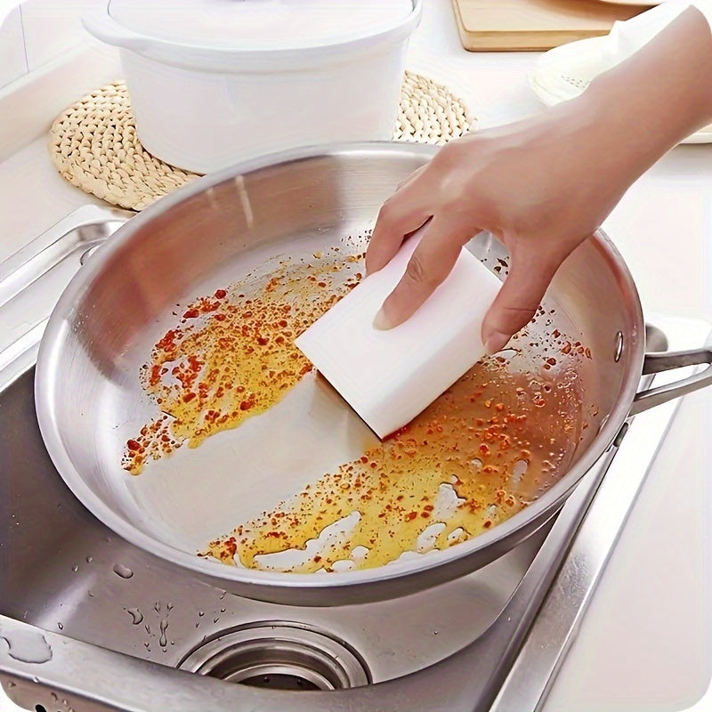 100 pieces of Magic Wipe Sponge made of Melamine Foam for household cleaning. This versatile sponge can be used for dishes, kitchen cleaning, car washing, and cleaning various surfaces such as sinks, ovens, stoves, plates, bathrooms, showers, tiles