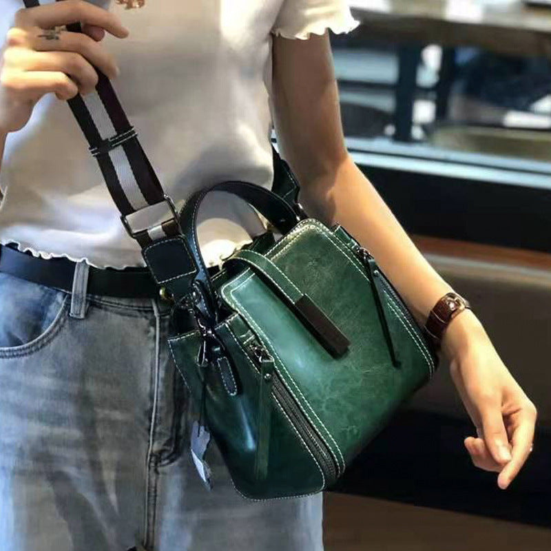 Stylish leather shoulder bag for women with removable strap, zipper closure, and edge paint detail. Available in black, coffee, and light brown.