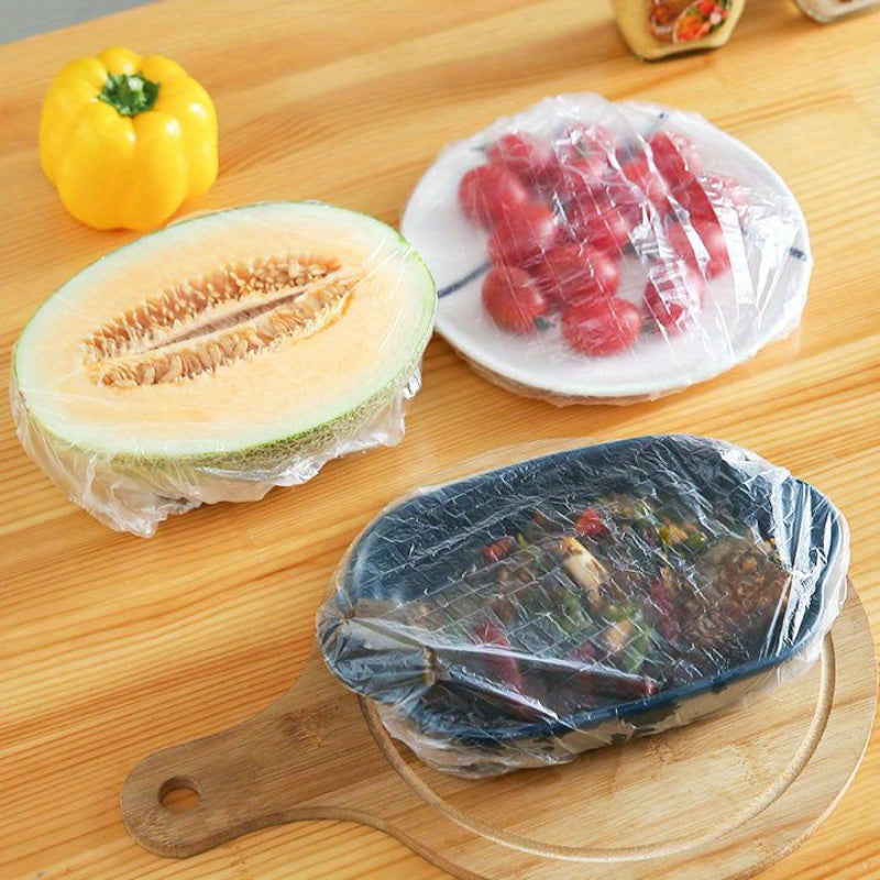 100 BPA-free plastic food covers in multiple sizes for sealing fruit, meals, and leftovers, providing durable, transparent, leak-proof freshness for the kitchen and dining.