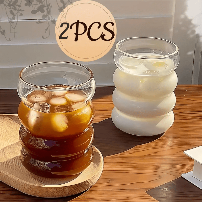 Two stylish thick glass milk and coffee cups, perfect for home use. These cups are reusable and durable, making them a great addition to your kitchen.