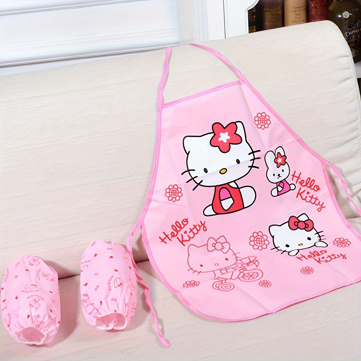 Hello Kitty Baby Bib Set made from durable linen blend with officially licensed design. Includes matching sleeves and woven polyethylene cover with acrylic lining. Suitable for cooking and