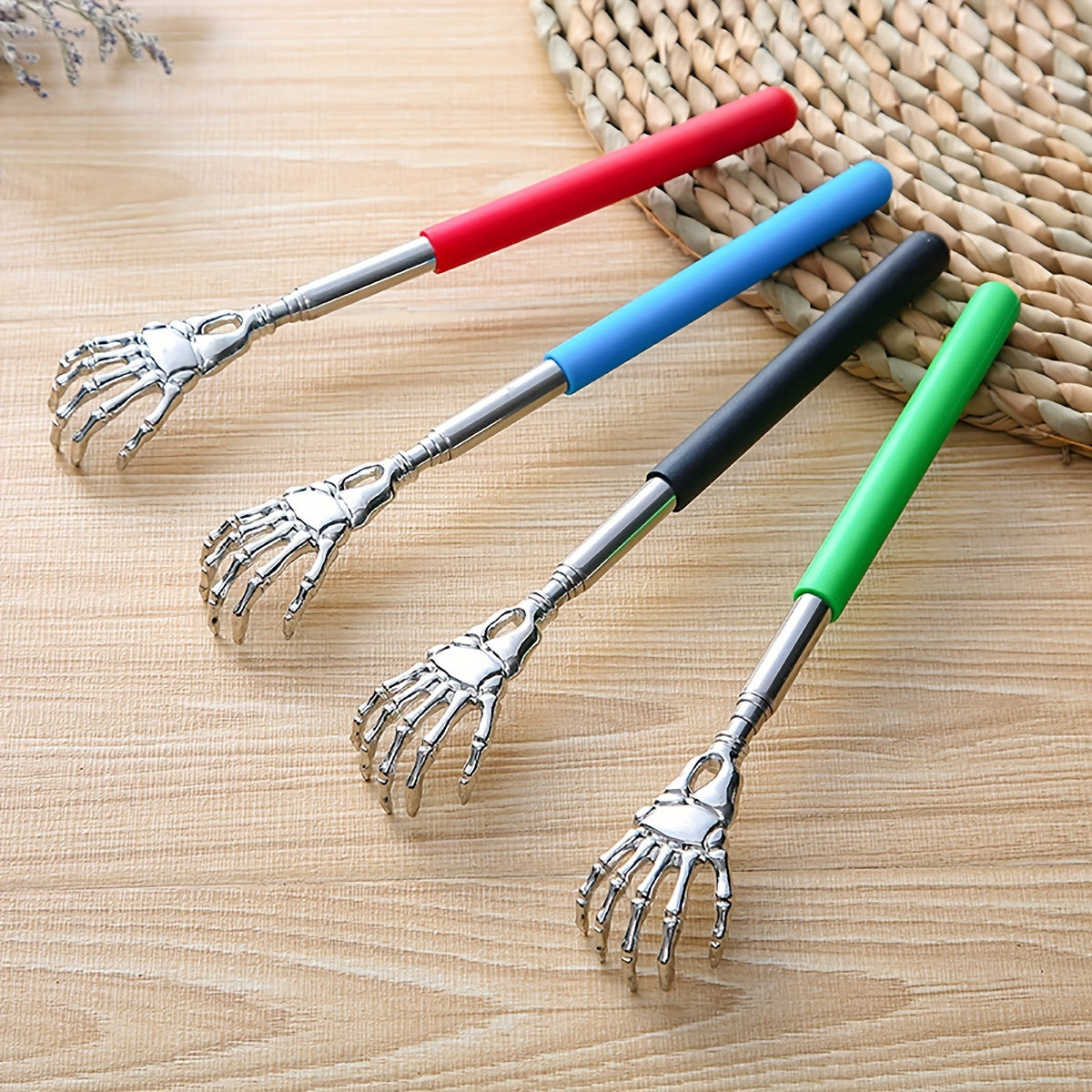 Extendable stainless steel back scratcher and massager with spooky skeleton hand design, adjustable length of 19.05cm to 69.85cm. Portable and durable construction.