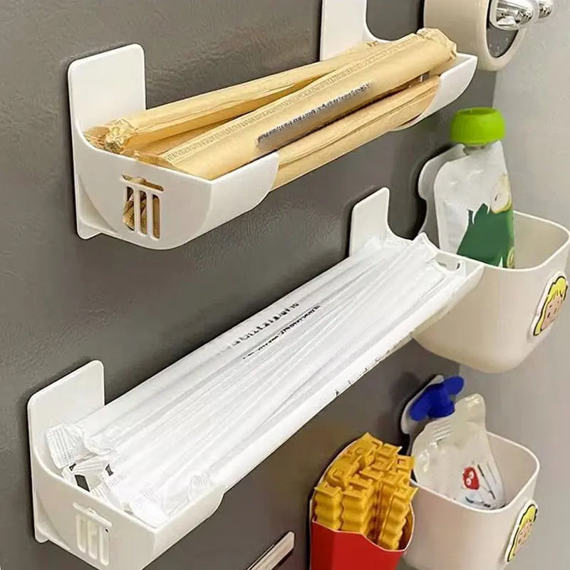 Wall-mounted storage organizer that saves space and holds plastic wrap and garbage bags without the need for drilling. Made of durable plastic, it is perfect for storing items on the side of the refrigerator.